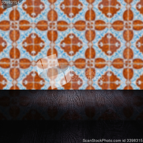 Image of Wood table top and blur vintage ceramic tile pattern wall