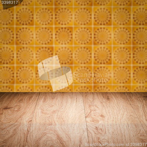 Image of Wood table top and blur vintage ceramic tile pattern wall