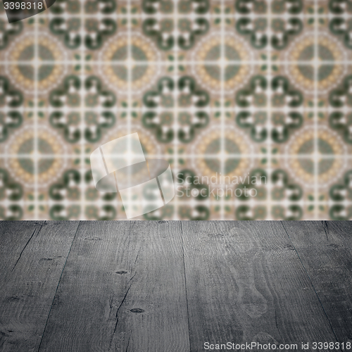 Image of Wood table top and blur vintage ceramic tile pattern wall