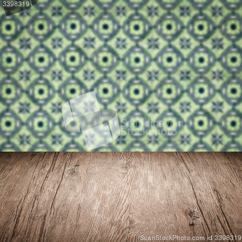 Image of Wood table top and blur vintage ceramic tile pattern wall