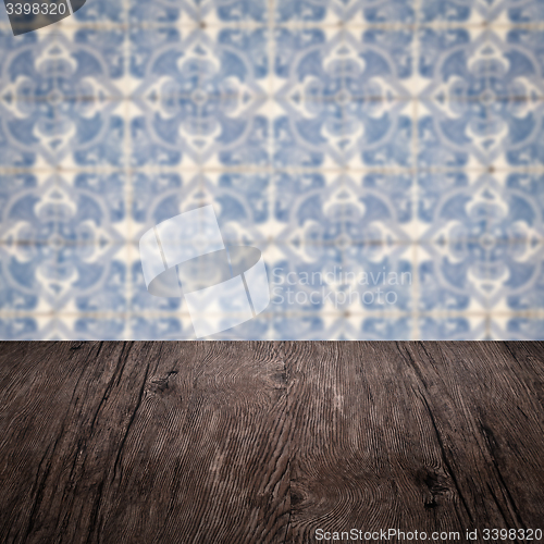 Image of Wood table top and blur vintage ceramic tile pattern wall