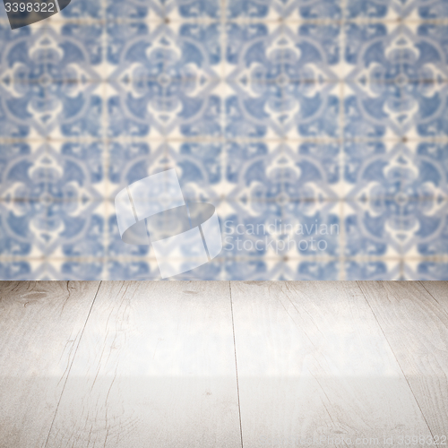 Image of Wood table top and blur vintage ceramic tile pattern wall