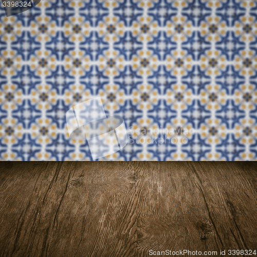 Image of Wood table top and blur vintage ceramic tile pattern wall