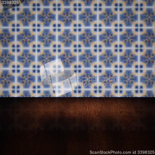 Image of Wood table top and blur vintage ceramic tile pattern wall
