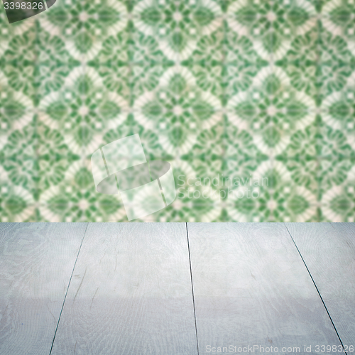 Image of Wood table top and blur vintage ceramic tile pattern wall