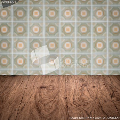 Image of Wood table top and blur vintage ceramic tile pattern wall