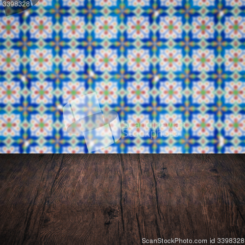Image of Wood table top and blur vintage ceramic tile pattern wall