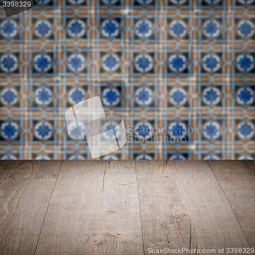 Image of Wood table top and blur vintage ceramic tile pattern wall