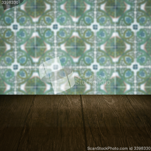 Image of Wood table top and blur vintage ceramic tile pattern wall