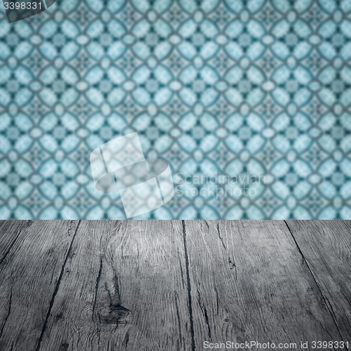 Image of Wood table top and blur vintage ceramic tile pattern wall