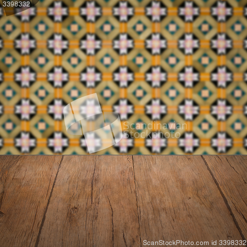 Image of Wood table top and blur vintage ceramic tile pattern wall