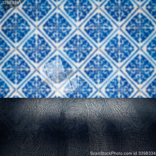 Image of Wood table top and blur vintage ceramic tile pattern wall