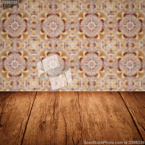 Image of Wood table top and blur vintage ceramic tile pattern wall