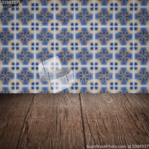 Image of Wood table top and blur vintage ceramic tile pattern wall