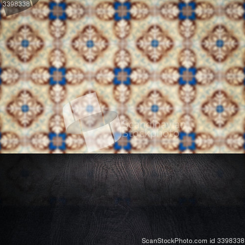 Image of Wood table top and blur vintage ceramic tile pattern wall