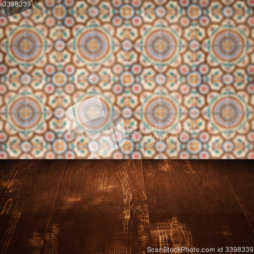 Image of Wood table top and blur vintage ceramic tile pattern wall