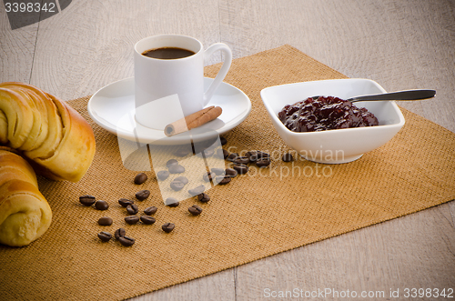 Image of Cup of black coffee and croissant 