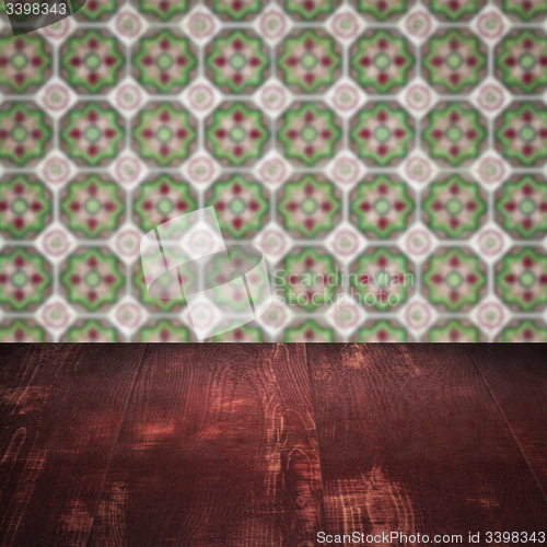 Image of Wood table top and blur vintage ceramic tile pattern wall