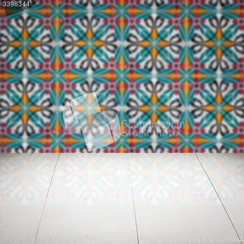 Image of Wood table top and blur vintage ceramic tile pattern wall