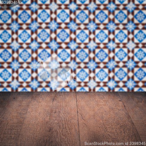 Image of Wood table top and blur vintage ceramic tile pattern wall