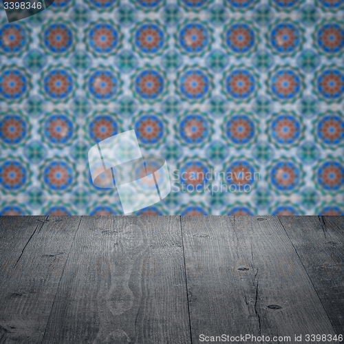 Image of Wood table top and blur vintage ceramic tile pattern wall