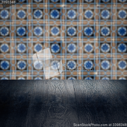 Image of Wood table top and blur vintage ceramic tile pattern wall