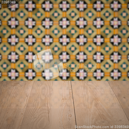 Image of Wood table top and blur vintage ceramic tile pattern wall