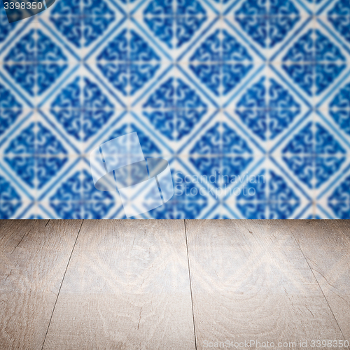 Image of Wood table top and blur vintage ceramic tile pattern wall