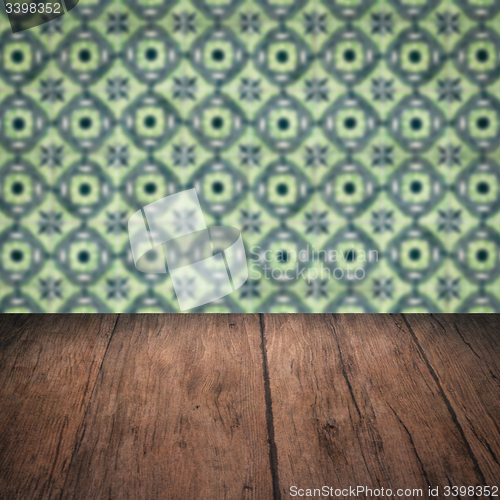 Image of Wood table top and blur vintage ceramic tile pattern wall