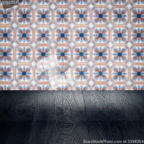 Image of Wood table top and blur vintage ceramic tile pattern wall