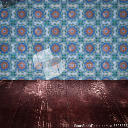 Image of Wood table top and blur vintage ceramic tile pattern wall