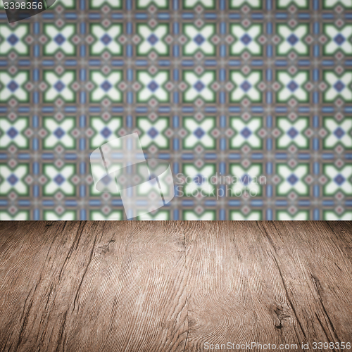 Image of Wood table top and blur vintage ceramic tile pattern wall