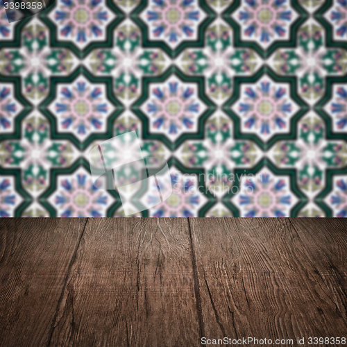 Image of Wood table top and blur vintage ceramic tile pattern wall