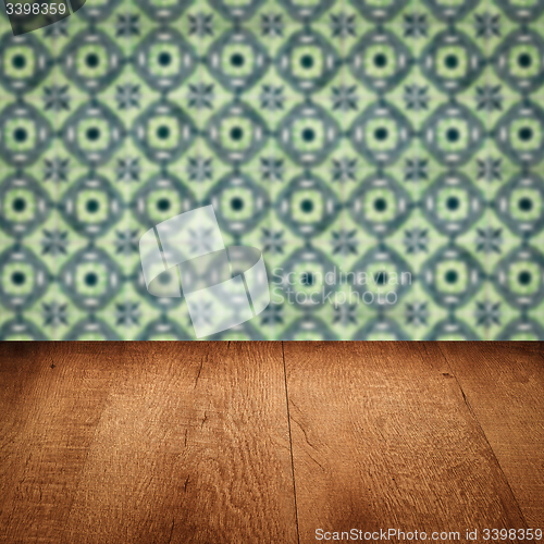 Image of Wood table top and blur vintage ceramic tile pattern wall