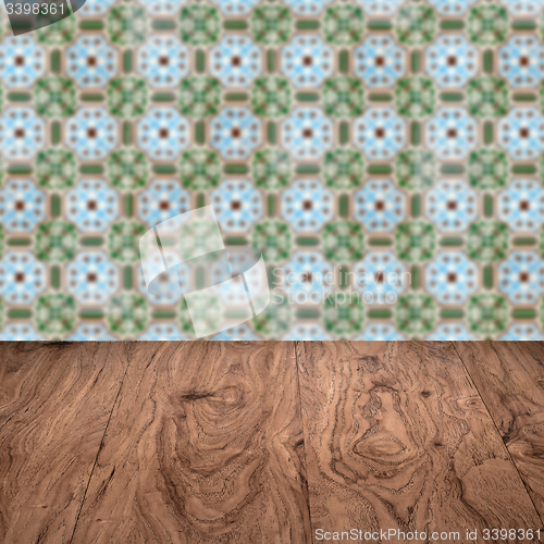 Image of Wood table top and blur vintage ceramic tile pattern wall