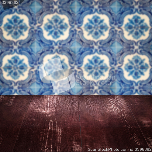 Image of Wood table top and blur vintage ceramic tile pattern wall