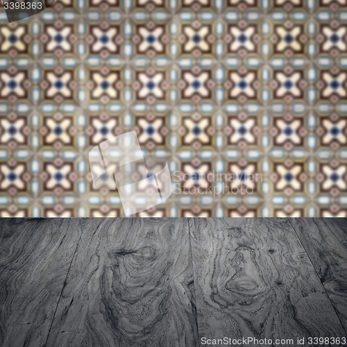 Image of Wood table top and blur vintage ceramic tile pattern wall