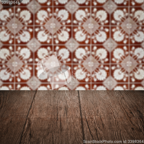 Image of Wood table top and blur vintage ceramic tile pattern wall