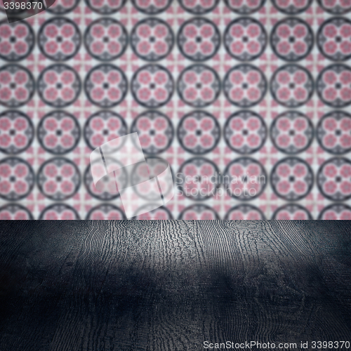 Image of Wood table top and blur vintage ceramic tile pattern wall