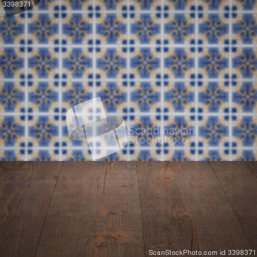 Image of Wood table top and blur vintage ceramic tile pattern wall