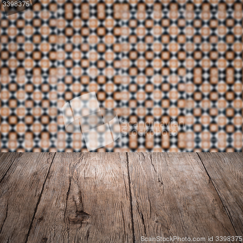 Image of Wood table top and blur vintage ceramic tile pattern wall