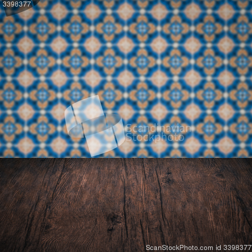 Image of Wood table top and blur vintage ceramic tile pattern wall