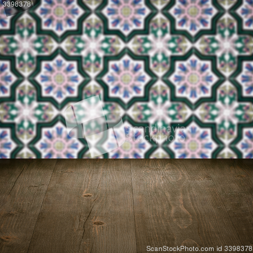 Image of Wood table top and blur vintage ceramic tile pattern wall