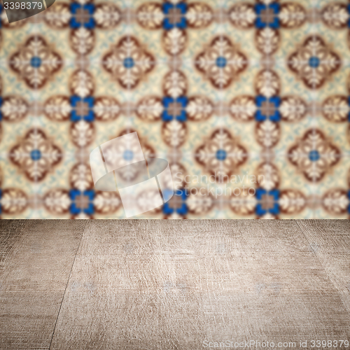 Image of Wood table top and blur vintage ceramic tile pattern wall