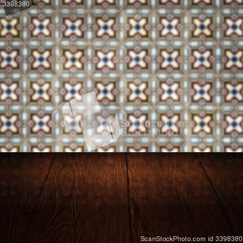 Image of Wood table top and blur vintage ceramic tile pattern wall