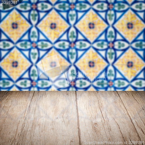 Image of Wood table top and blur vintage ceramic tile pattern wall