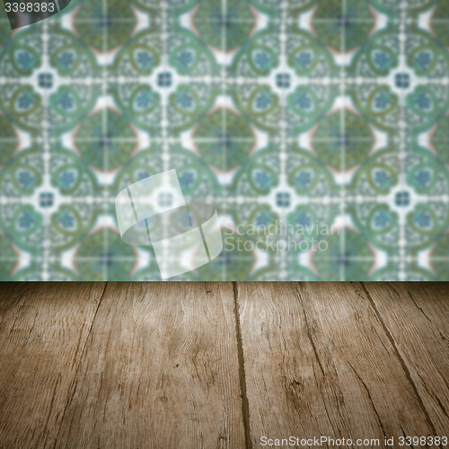 Image of Wood table top and blur vintage ceramic tile pattern wall