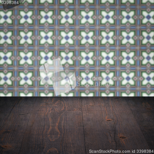 Image of Wood table top and blur vintage ceramic tile pattern wall