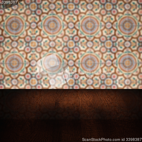 Image of Wood table top and blur vintage ceramic tile pattern wall