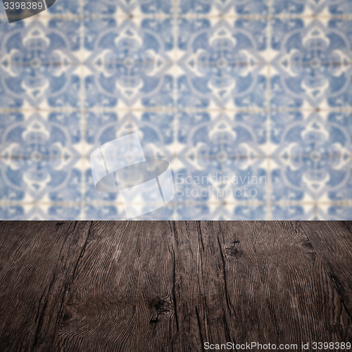 Image of Wood table top and blur vintage ceramic tile pattern wall